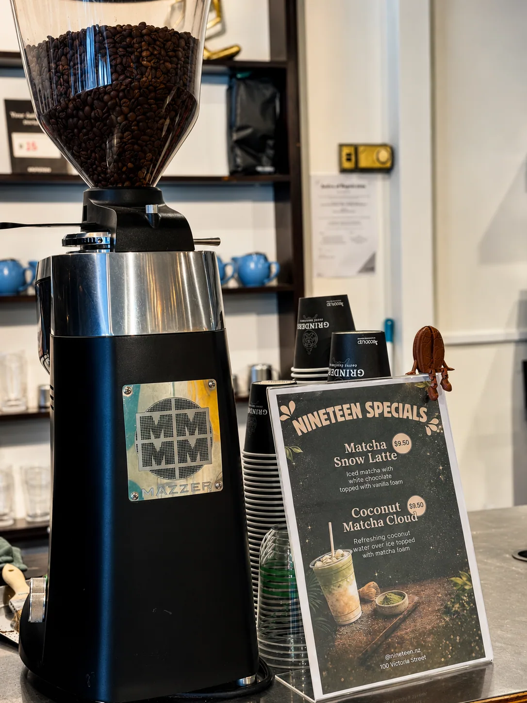 Coffee grinder and Cafe Nineteen specials board